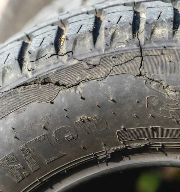 Close-up of a dry-rotted tire sidewall showing heat damage common on vehicles in Ocala, FL